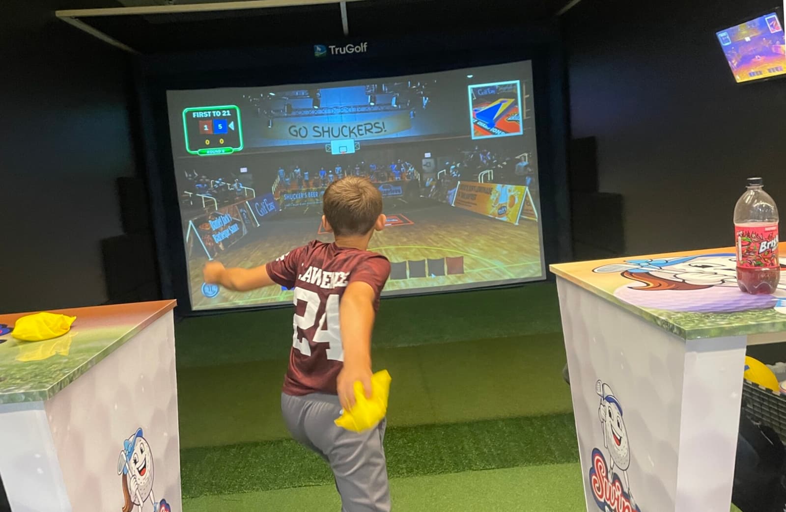 A young player tossing in the multi-sport bay during a party