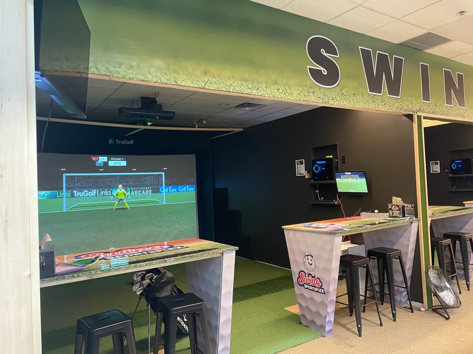 Multi-sport soccer on the TruGolf bay at Swing Sportsplex with branded high-top seating